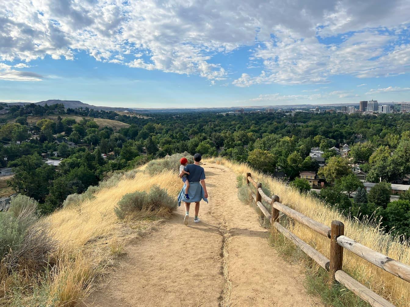 Carla carrying Baby O on a trail outside of Boise