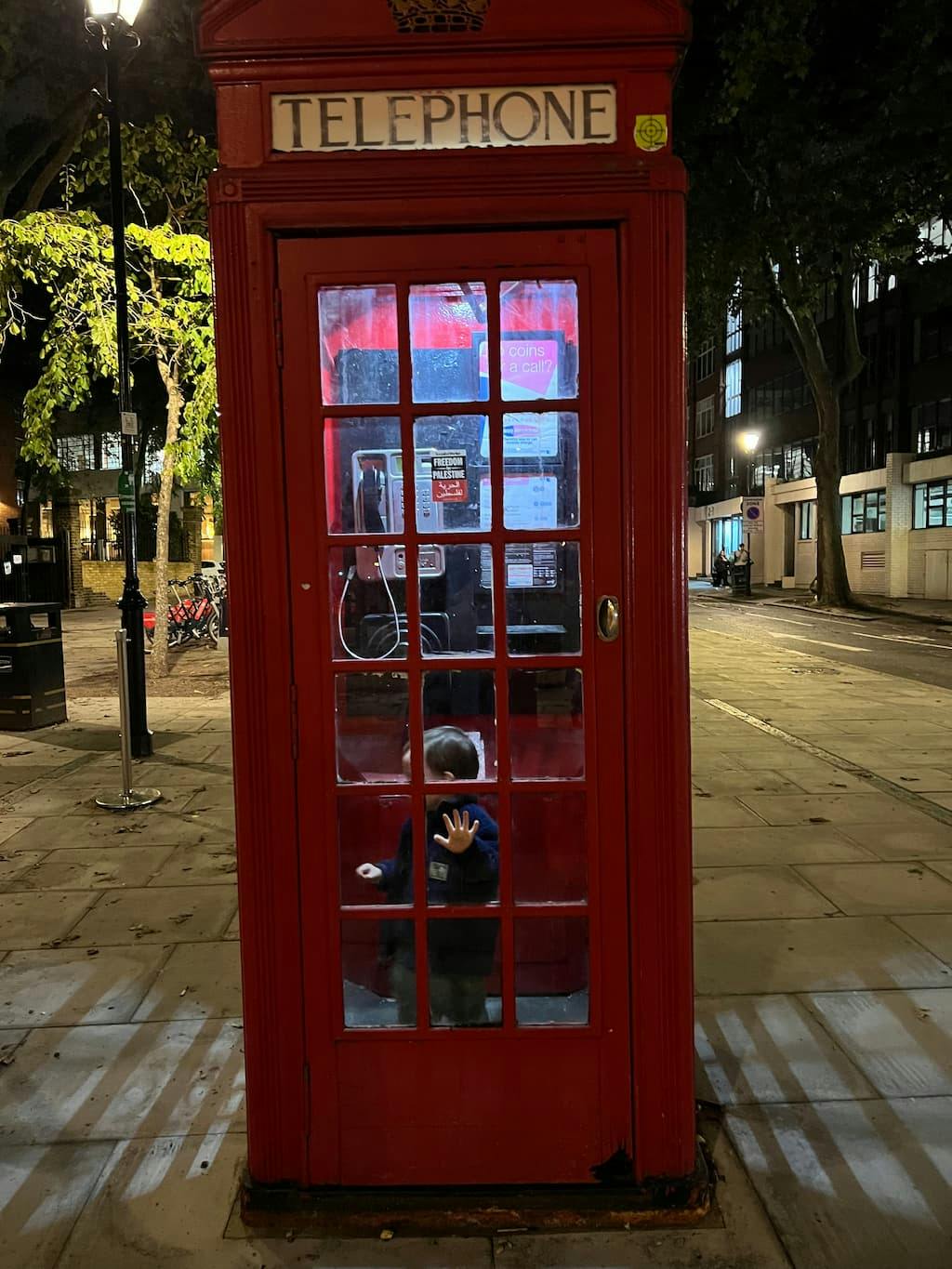 O in a classic red phone booth in London